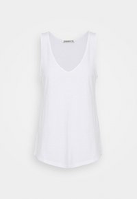 Top bianco senza maniche realizzato in tessuto leggero, con una scollatura a V profonda e una vestibilità rilassata con orlo curvo.