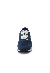 Navy blue athletic shoe featuring a mix of smooth and textured fabric, white laces, and a contrasting black outsole.