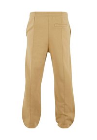 Beige katoenen sweatpants met een ontspannen pasvorm, voorzien van een elastische tailleband, zijkanten en een enkele achterzak. Glad textuur.