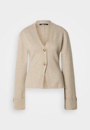 Cardigan beige a V con maniche lunghe, due bottoni in bachelite sul davanti e polsini con bottone, esposto su sfondo bianco.