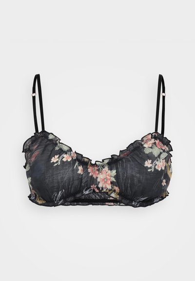 Mustassa kukkakuosisessa braletissa on röyhelöreunat, ohuet mustat hihnat ja tekstuuri, jossa on läpinäkyvä kangas vaaleanpunaisilla ja vihreillä kukkakuviolla.