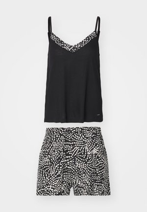 Black cami top with a patterned white and black shorts. The top features thin straps and a v-neckline; shorts have a fluid, wavy design.