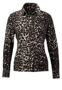 Langærmet, knappet skjorte med sort og hvid leopardmønstret mønster og en spids krave.