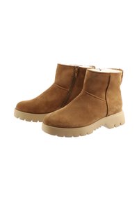 Une paire de bottines en suède marron avec fermeture éclair sur le côté et semelles en caoutchouc beige, dotées d'un intérieur en doux polaire blanc.