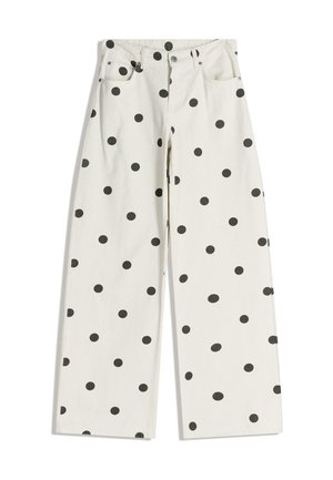 Vita vida byxor med prickigt mönster i svart. Tillverkade av bomull med standardfickor och dragkedja framtill.