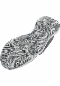 Black and white sneaker sole with a wavy texture, featuring a unique pattern of grooves and ridges, designed for traction and grip.