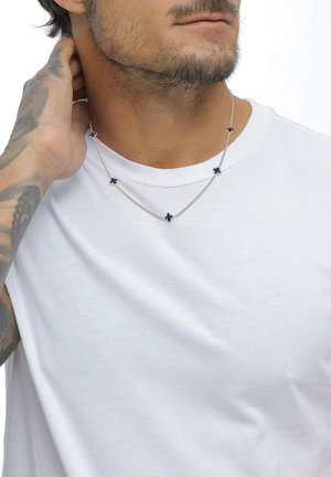 Silver chain necklace featuring blue floral accents, consisting of five small flower-shaped details evenly spaced along the chain.