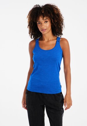 Blue tank top in a soft, ribbed texture with wide straps and a rounded neckline, paired with black, loose-fitting pants.
