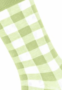 Zielono-białe skarpetki w kratkę o miękkiej teksturze dzianiny, z naprzemiennymi pastelowymi kwadratami i prążkowanym mankietem.