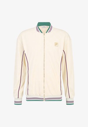 Chaqueta bomber crema con cremallera, cuello verde, rayas moradas en las mangas y el dobladillo, con un logo dorado en el lado izquierdo del pecho, de tela texturizada.