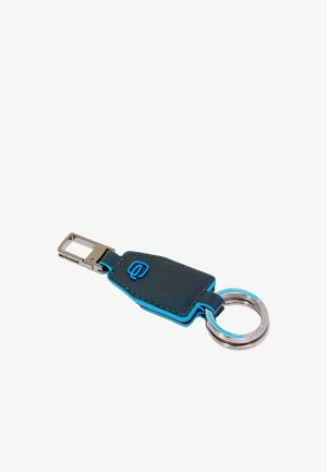 Leather keychain with a dark navy body, bright blue stitching, a rectangular metal clasp, and a silver keyring. Features embossed logo detail.