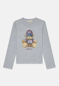 Hallikas pika varrukaga särk, millel on karu graafika, kes kannab päikeseprille ja jopet numbriga 10. 'Twinset' logo trükitud karu alla.