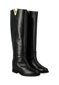 Bottes en cuir noir jusqu'au genou au design épuré, avec un accent doré en forme de "V" sur le haut. Semelle plate et texture lisse.