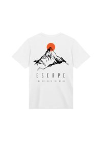 White cotton t-shirt featuring a black mountain graphic with an orange sun above, and the text "ESCAPE AND DISCOVER THE WORLD."
