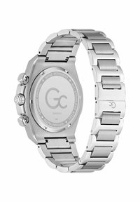 Roostevabast terasest kell, millel on massiivne ristkülikukujuline korpus, metallist lingirihm ja poleeritud pind. Näitab Šveitsi mehaanikat ja on veekindel.