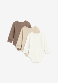 Tre body per neonato a maniche lunghe a coste, di colore marrone, beige e bianco sporco, posizionati piatti con le maniche ripiegate su uno sfondo bianco.