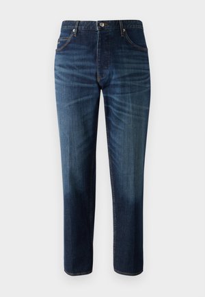 Jeans in denim blu scuro con taglio dritto, cinque tasche e cuciture a contrasto. Il materiale è liscio con un leggero sbiadimento sulle cosce.