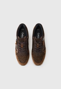 Brown suede sneakers with a textured mesh pattern, lace-up design, and side zipper for easy access. Features a cushioned insole.
