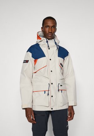 White waterproof jacket with blue and orange accents, featuring a hood, multiple pockets, and adjustable drawstrings at the waist.