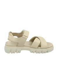 Beige sandal with cross-strap design, adjustable ankle strap, and durable, textured outsole. Made from smooth synthetic material.