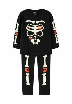 Pyjamas noirs pour enfants avec des os de squelette phosphorescents, des cranes orange et des motifs de toiles d'araignée sur le haut et le pantalon.