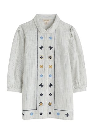 Button-up blouse in lightweight striped fabric. Features embroidered floral patterns in blue, black, and yellow on a light background. Puff sleeves.