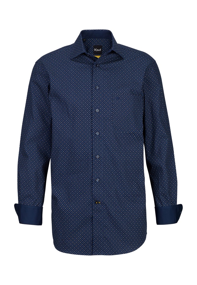 Marineblaues Hemd mit Knöpfen, das ein kleines weißes Punktemuster aufweist, lange Ärmel mit aufgerollten Manschetten und einer Brusttasche auf der linken Seite.
