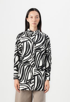 Black and white button-up shirt featuring a swirling striped pattern, collar, long sleeves, and relaxed fit. Smooth fabric texture.