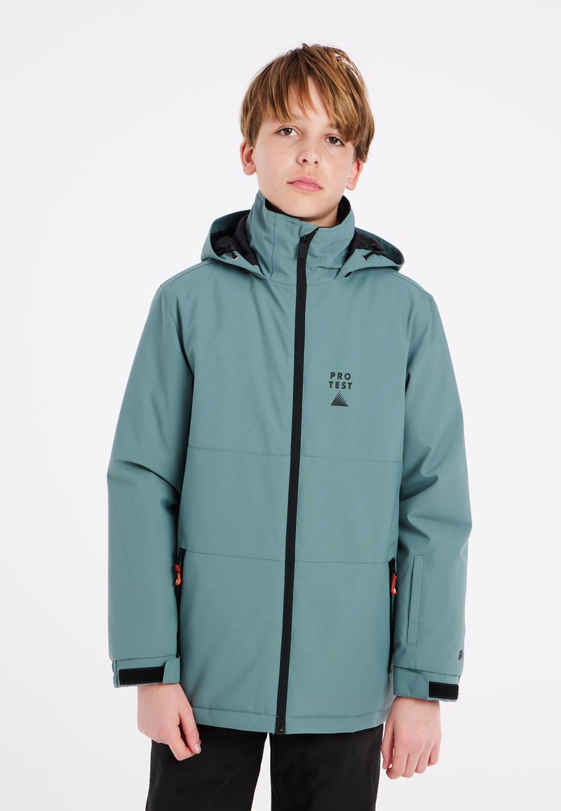 Veste imperméable vert clair avec capuche ajustable, accents noirs, fermeture éclair à l'avant et logo. Texture douce avec poches latérales.