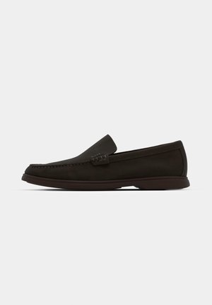 Dark brown suede slip-on loafers with a stitched toe, low-profile rubber sole, and textured accents on the upper.