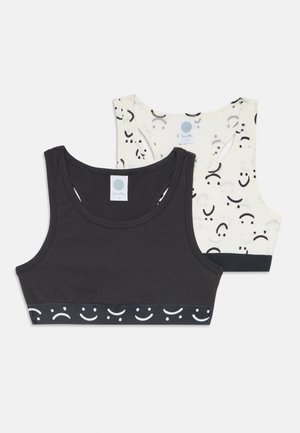 To t-skjorter: en svart med et hvitt smilefjesmønster på kanten, og en kremfarget med svarte smilefjes. Blandingsstoff av bomull.