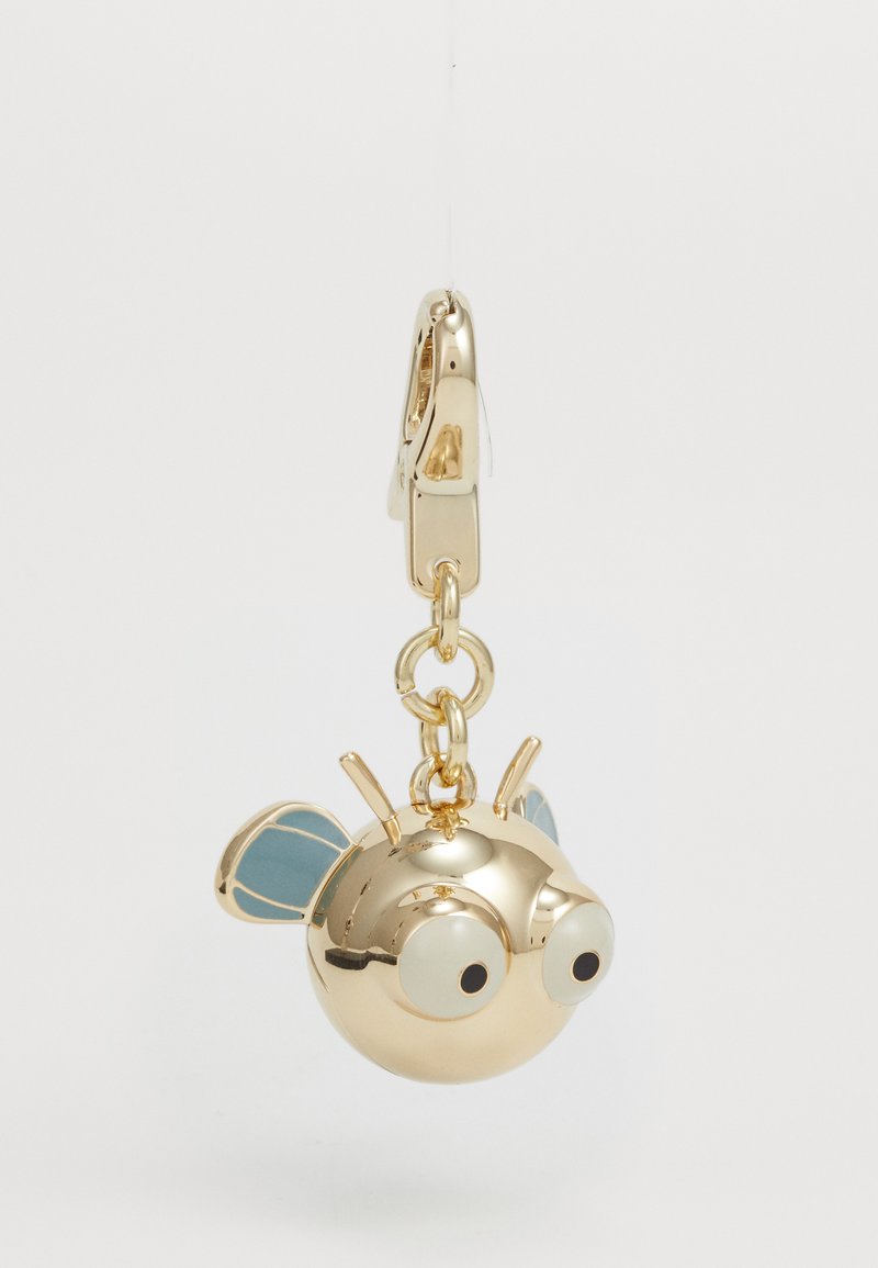 Gold insect-shaped charm with large white eyes, blue accents on wings, and a clasp attachment. Smooth surface with a reflective finish.