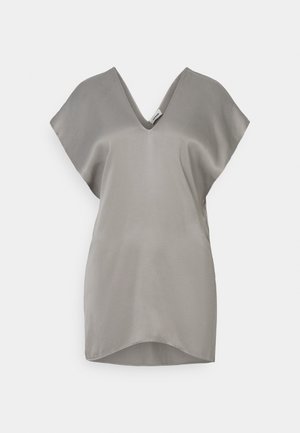 Grey silk blouse featuring a V-neck, short cape sleeves, and a rounded hem. The fabric has a smooth, shiny texture.