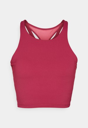Różowa bluzka crop top z wycięciem na plecach. Wykonana z elastycznego materiału, charakteryzującego się gładką fakturą i kontrastową podszewką.