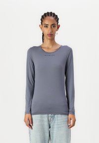 Long-sleeve, slim-fit shirt in a muted gray color. Smooth, stretchy fabric with a round neckline, featuring "BLANCHE" logo in black.