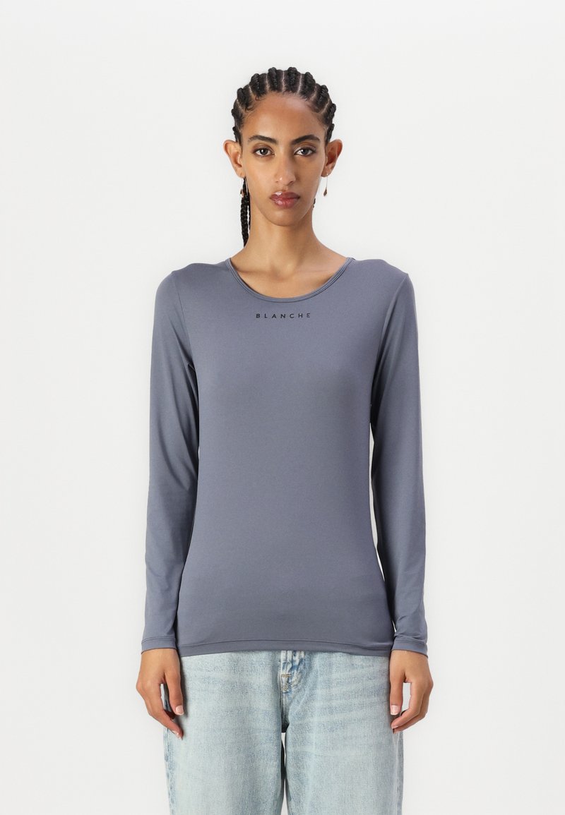Long-sleeve, slim-fit shirt in a muted gray color. Smooth, stretchy fabric with a round neckline, featuring "BLANCHE" logo in black.
