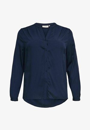 Chemise à manches longues bleu marine avec un col en V et une fermeture à boutons, présentant une texture lisse et un léger froncé aux épaules.