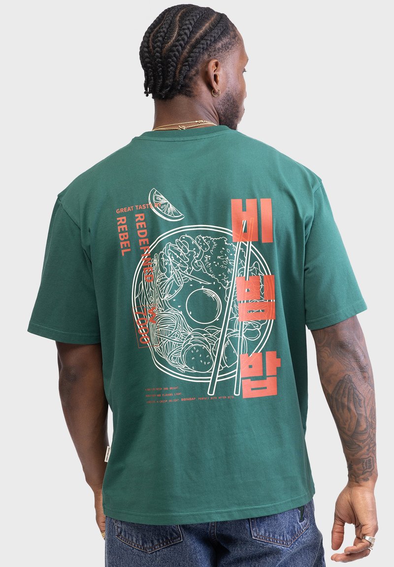 Green cotton t-shirt featuring a large graphic of a bowl of food with chopsticks, orange text, and a lime slice illustration on the back.