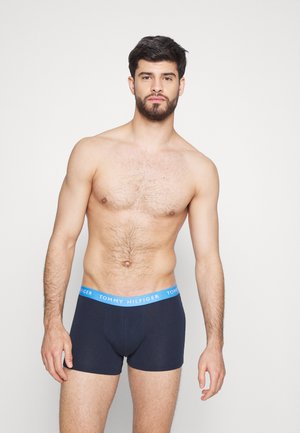 Boxers en coton bleu marine avec une ceinture "TOMMY HILFIGER" bleu clair, offrant une coupe ajustée et des coutures minimales pour plus de confort.