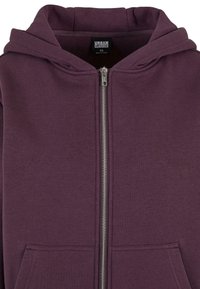 Sweat à capuche zippé violet foncé avec poches avant, fermeture éclair argentée visible et capuche attachée, taille XS avec étiquette Urban Classics à l’intérieur du col.