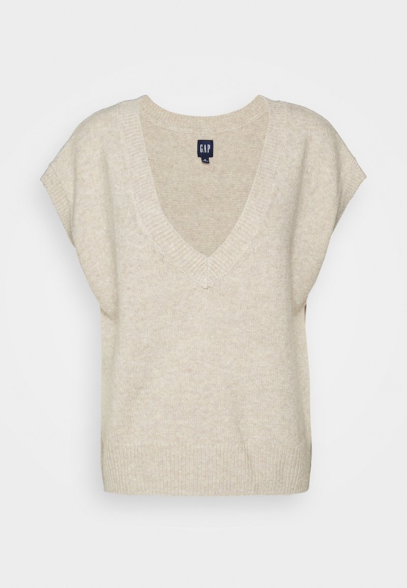 Pull beige tricoté avec un col en V, des manches courtes et un ourlet côtelé. Texture douce, design minimaliste et étiquette de marque visible au niveau du col.