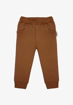 Brązowe bawełniane spodnie dresowe z elastycznym pasem, dwoma bocznymi kieszeniami i ściągaczami przy kostkach. Gładka faktura i luźny krój.