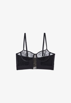 Black lace bralette featuring sheer mesh panels, molded cups, adjustable straps, and textured fabric accents, creating a layered design.