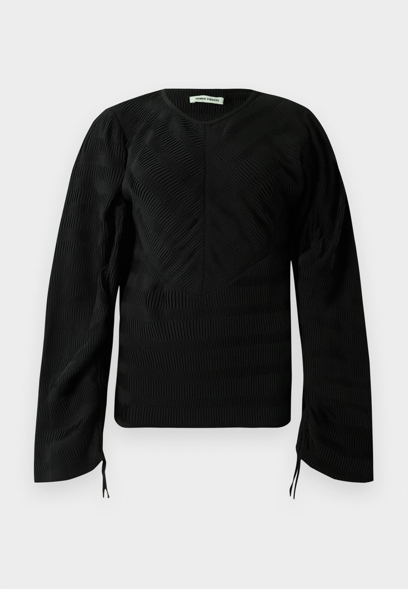 Black long-sleeve textured top with subtle wavy patterns, crew neckline, slightly puffed shoulders, and small ties at the sleeve ends.