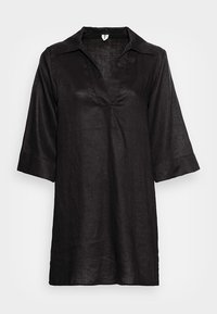 Tunique en lin noire avec manches trois-quarts et col en V, coupe ample et design simple.