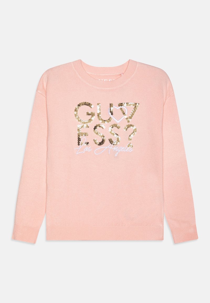 Pull rose clair à manches longues, arborant un graphisme en sequins dorés avec les mots "GUESS?" et "Los Angeles" en cursive au centre.