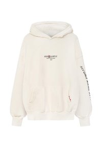 Kremowa bluzka z kapturem, z przednią kieszenią, sznurkiem w kapturze oraz nadrukowanym tekstem na klatce piersiowej i rękawie. Miękka, bawełniana tkanina z prążkowanymi mankietami.