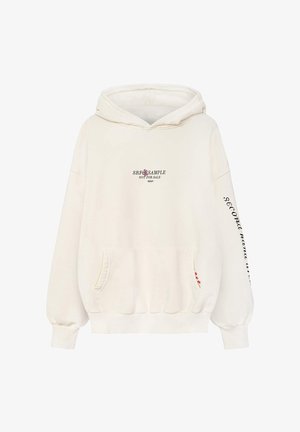 Kremowa bluzka z kapturem, z przednią kieszenią, sznurkiem w kapturze oraz nadrukowanym tekstem na klatce piersiowej i rękawie. Miękka, bawełniana tkanina z prążkowanymi mankietami.