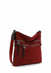 Borsa a spalla in tessuto rosso con due tasche frontali con zip, dettagli in marrone scuro e una tracolla rimovibile. Texture liscia, design minimalista.