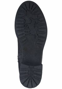 Suola di scarpa in gomma nera con superficie rigata, motivo a stella e indicazione della misura "37." Testurizzata per garantire aderenza e durata.